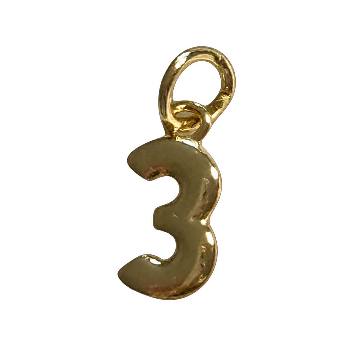 Number Three Charm with natural gold finish on transparent background