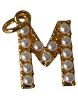 Gold pearl letter M charm on transparent background